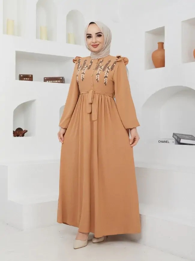 Woman in a camel Turkish gown with gold embroidery